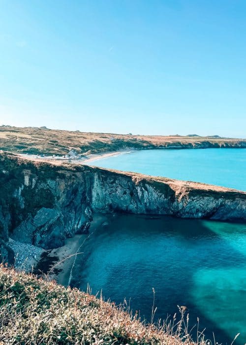 Piercing blue waters lapping at craggy limestone cliffs from Whitesands to Porthgain on the Pembrokeshire Coast Path, Wales