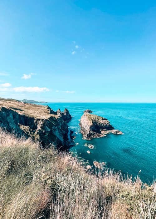 Turquoise ocean lapping at the craggy limestone rocks along the Pembrokeshire Coastal Path from Whitesands to Portgain, Wales