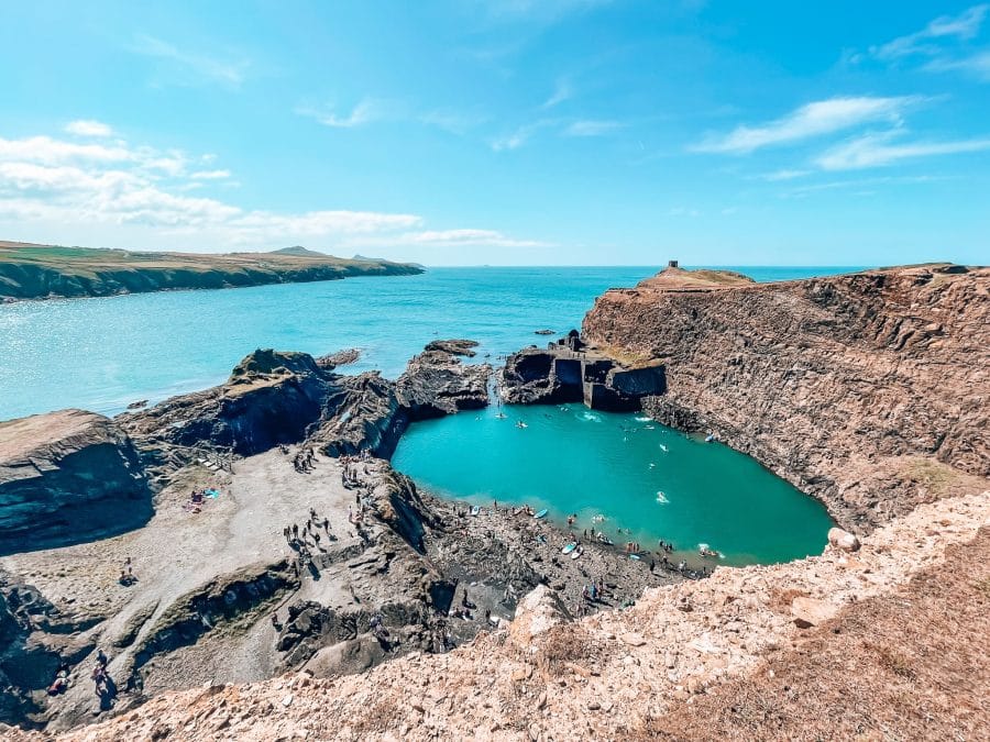 The piercing emerald Blue Lagoon with vast turquoise ocean behind, Abereiddy, Walking the Pembrokeshire Coast Path