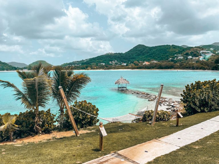 Stepping stones over the crystal clear water leading to a little hut at Cocobay Resort, Antigua