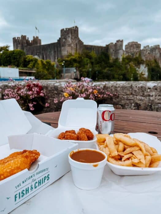 Fish and chips overlooking Pembroke Castle, Pembrokeshire, Wales, UK