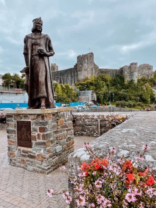 Statue dominating the frontline in front of Pembroke Castle, Pembrokeshire, Wales, UK