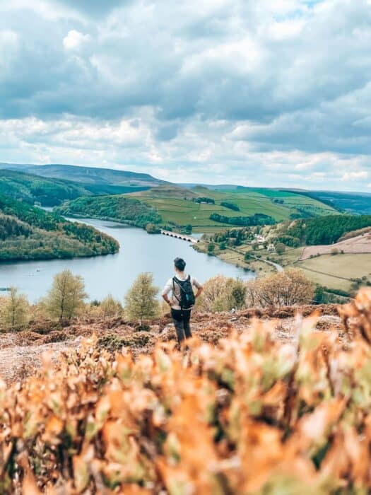 Andy looking out across the beautiful Ladybower Reservoir at Bamford Edge, Peak District, England, UK