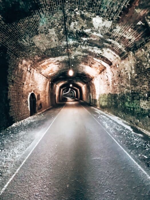 walking through Headstone Tunnel along the Monsal Trail, Peak District, UK