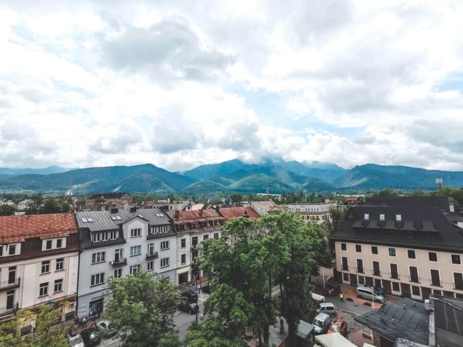 Colourful roofed houses with a dramatic mountain backdrop in Zakopane, Tatra Mountains, Poland