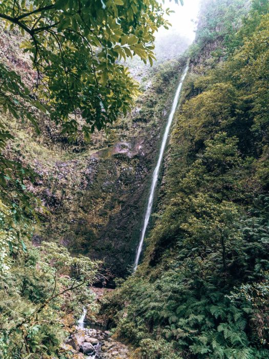 A huge narrow waterfall thundering down a steep wall, Caldeirão Verde, Hikes in Madeira, Portugal