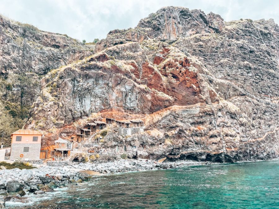 Swimming in the crystal clear water at Calhau da Lapa with a backdrop of the fishermen's houses is one of the best things to do in Madeira, Portugal