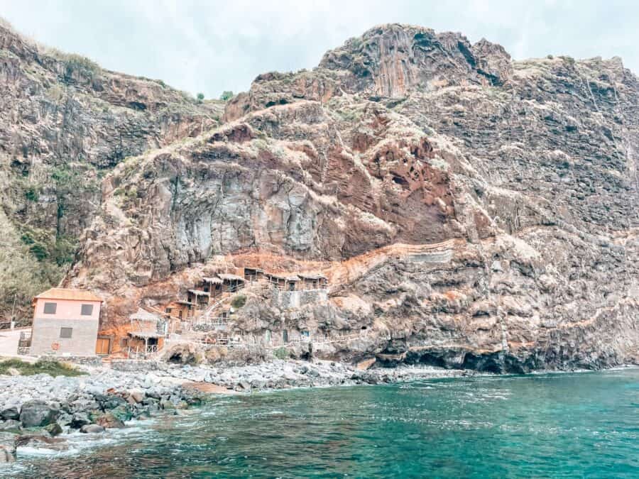 Swimming in the crystal clear water at Calhau da Lapa with a backdrop of the fishermen's houses is one of the best things to do in Madeira, Portugal