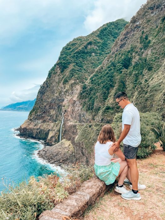 Viewpoint at Veu da Noiva across the ocean to a waterfall cascading out of the cliffs, Madeira, Portugal