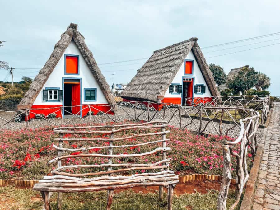 Visiting the red, white and blue triangular houses in Santana is one of the best things to do in Madeira, Portugal