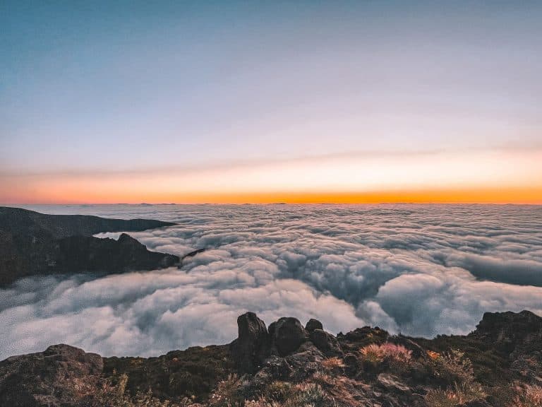 Sunrise at the Pico do Arieiro Viewpoint with the golden and orange hues above the clouds, Madeira, Portugal