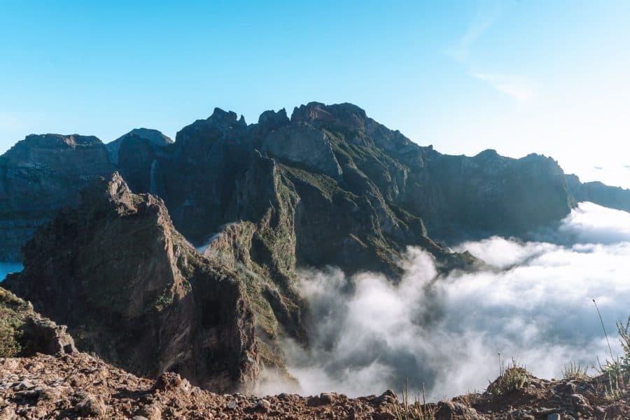 View across Madeira's craggy central mountains with candy floss clouds floating peacefully below, Pico do Arieiro, Portugal