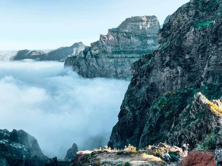 View across Madeira's craggy central mountains with candy floss clouds floating peacefully below, Pico do Arieiro, Portugal