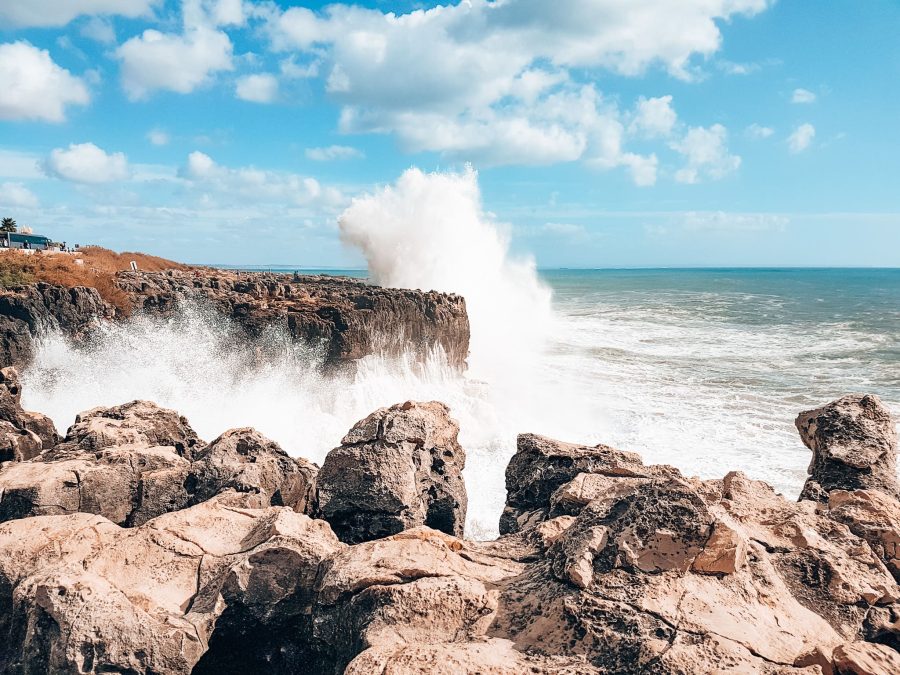 A huge wave crashing into the rocks at Boca do Inferno, Cascais, day trips from Lisbon by train