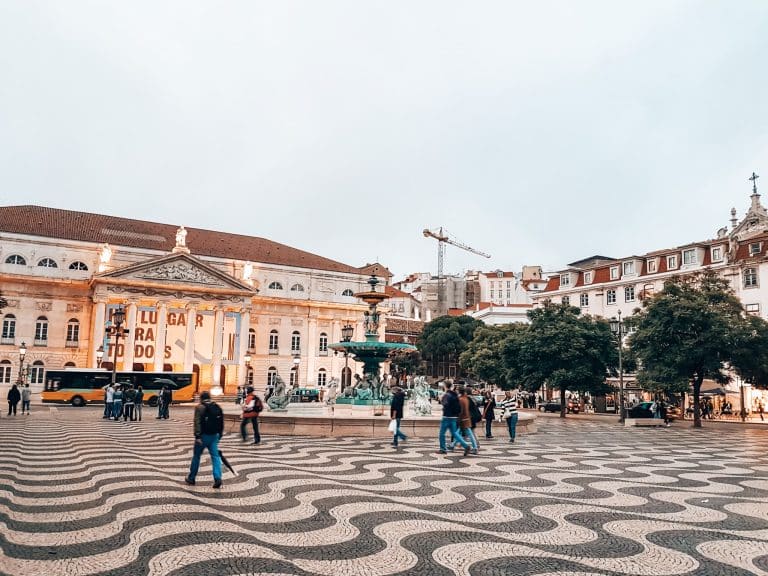 The opulent Rossio Square with grand buildings, places to visit in Lisbon