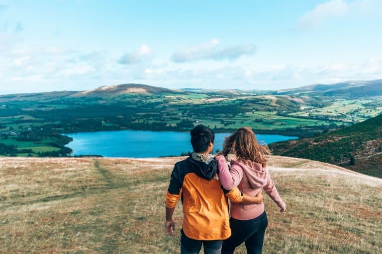 Andy and Helen stood at the top of Sale Fell overlooking Bassenthwaite Lake is one of the best things to do in the Lake District National Park, England, UK