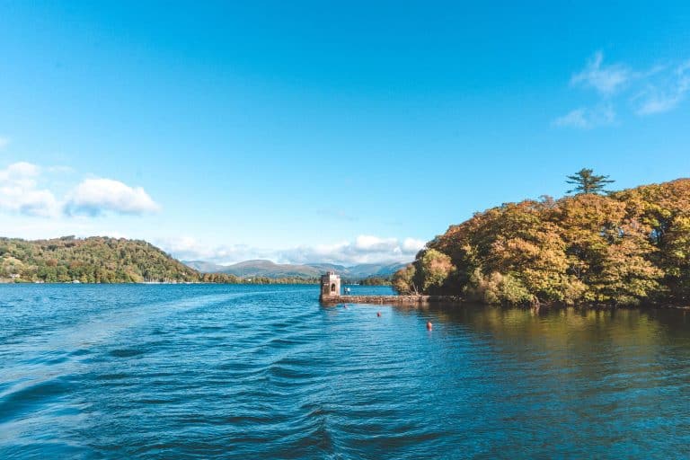 The wooded islands and mountains surrounding the calm water of Lake Windermere, Lake District National Park, England