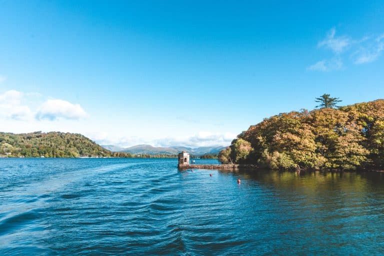 The wooded islands and mountains surrounding the calm water of Lake Windermere, Lake District National Park, England