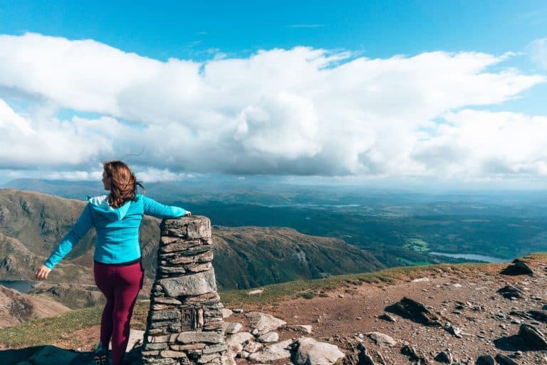 Helen stood at the summit of the Old Man of Coniston overlooking the surrounding mountainscapes in the Lake District, England