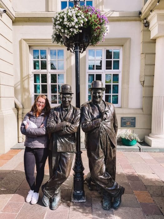 Helen stood with a statue of Laurel and Hardy in Ulverston, Lake District National Park, England