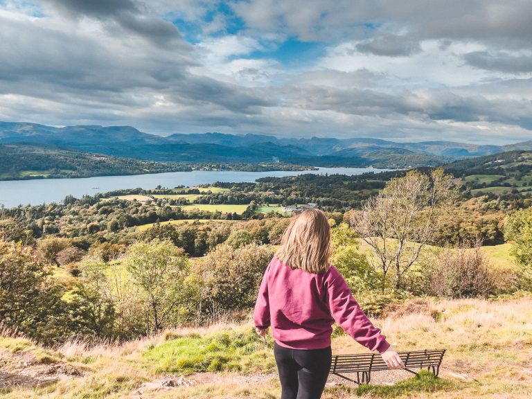 Helen stood at the peak of the Orrest Head Viewpoint overlooking Lake Windermere in the Lake District National Park, England