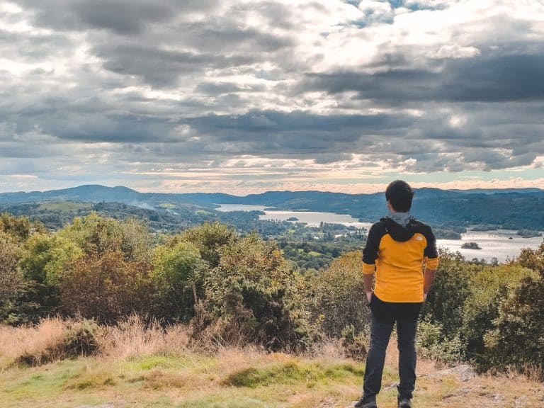 Andy stood on the summit of Orrest Head looking over Lake Windermere in the Lake District, England, UK