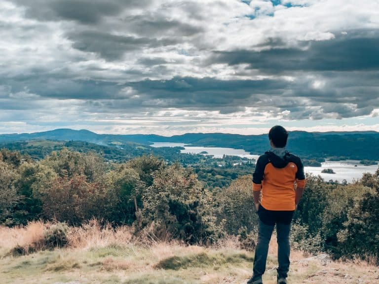 Andy stood on the summit of Orrest Head looking over Lake Windermere in the Lake District, England, UK