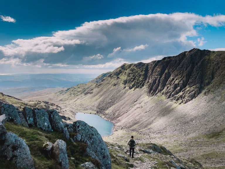 Andy overlooking a lake on the Old Man of Coniston, best things to do in the Lake District