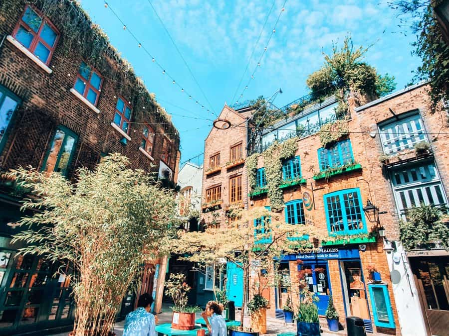 Neal's Yard with its vibrant coloured buildings, trees and benches, Covent Garden, free things to do in London, England, UK