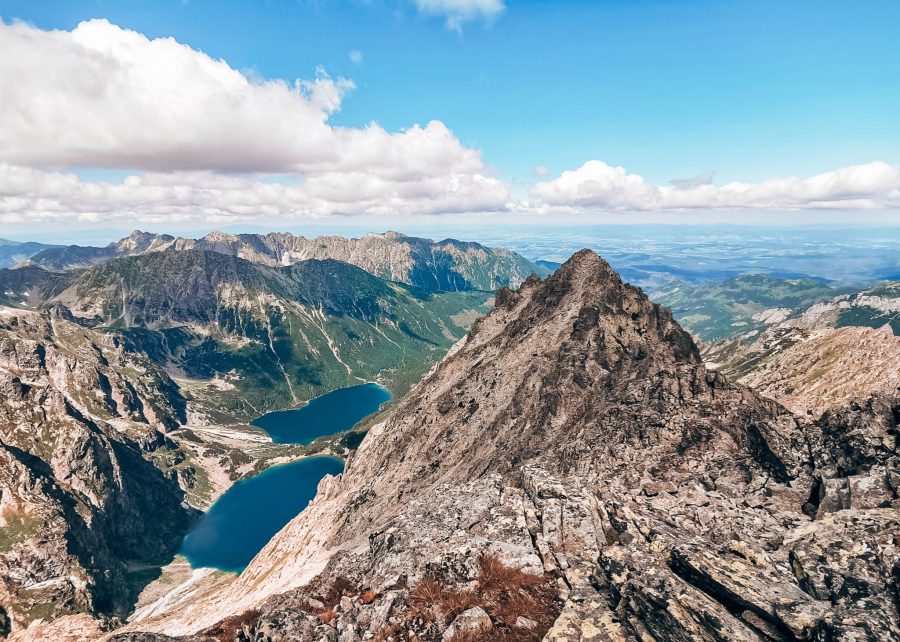 The view at Rysy Mountain summit over the surrounding jagged peaks with Czarny Staw and Morskie Oko lakes below, Zakopane, Poland