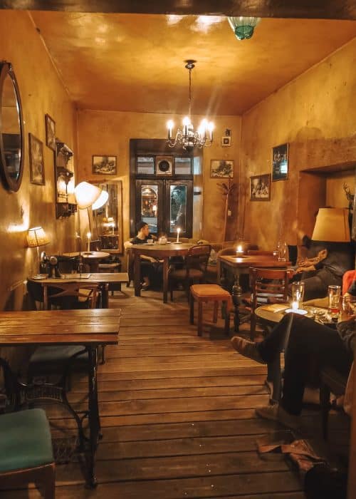 Sitting in the cosy Bar Eszeweria with its homely decor and armchairs is one of the best things to do in Krakow, Poland