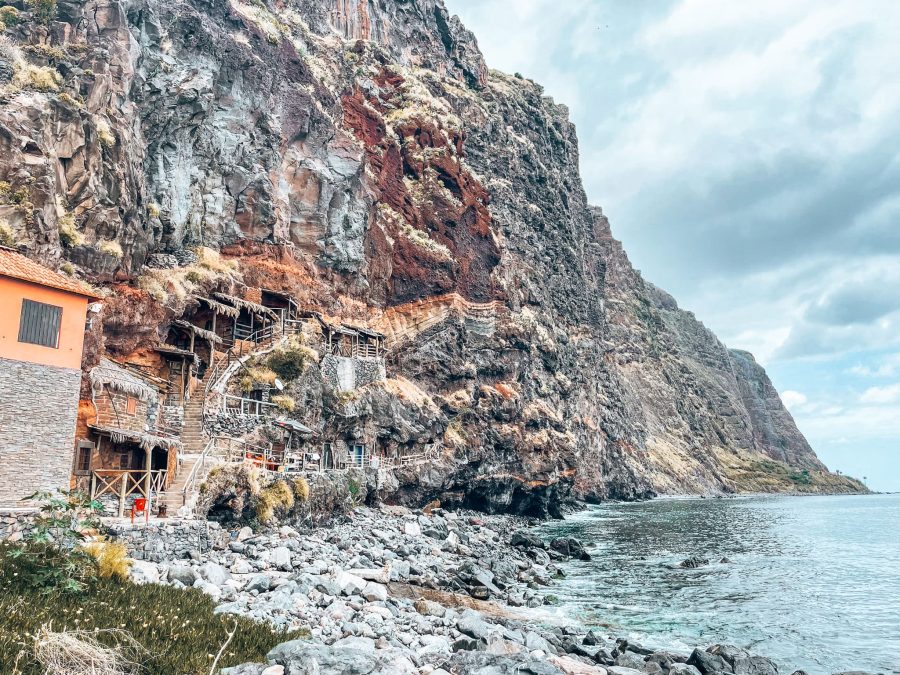 Traditional fishermen's cave houses built into the side of a cliff at Calhau da Lapa, best hidden gems in Madeira, Portugal