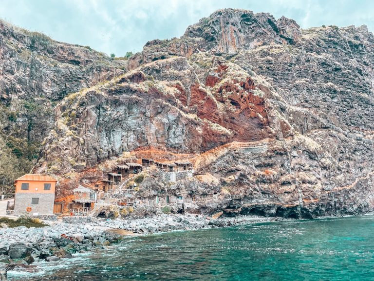 Traditional fishermen's cave houses built into the side of a cliff at Calhau da Lapa, best hidden gems in Madeira, Portugal