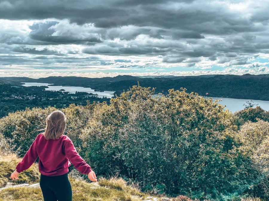 Helen stood at the peak of the Orrest Head Viewpoint overlooking Lake Windermere in the Lake District National Park, England