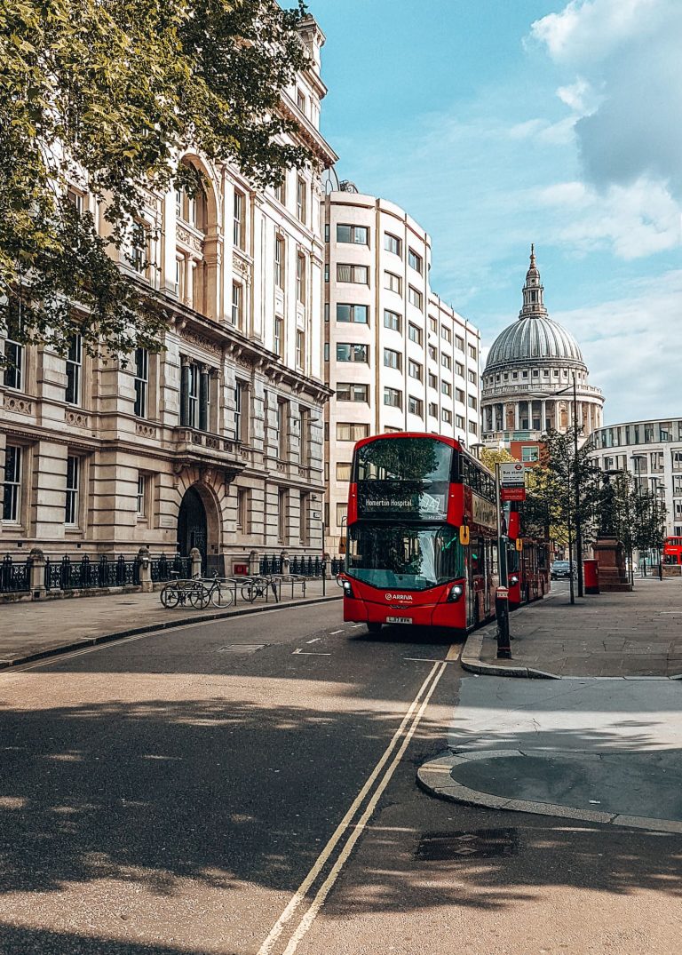 An iconic red London bus with St Paul's in the background, City of London, England, Transport for London, UK