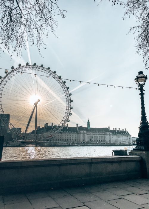 The London Eye towering above the River Thames with the sunrise behind, London, England, UK