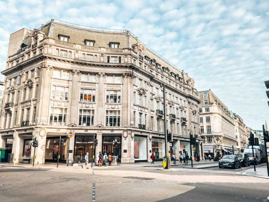 The grand buildings and wide road of Oxford Street home to many high-street stores, London