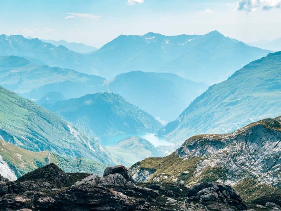 View to a tranquil lake nestled beneath the French Alps at the Col du Bonhomme, on the Tour du Mont Blanc, France, French Alps