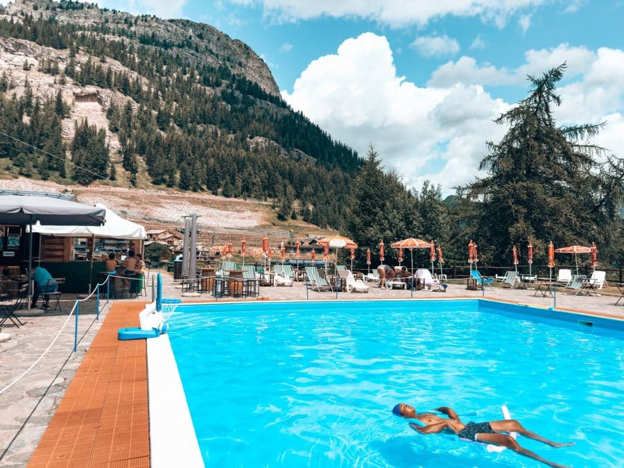 Andy floating in the Alpine Pool with a mountain backdrop in Courmayeur, Aosta Valley, Tour du Mont Blanc, Italy