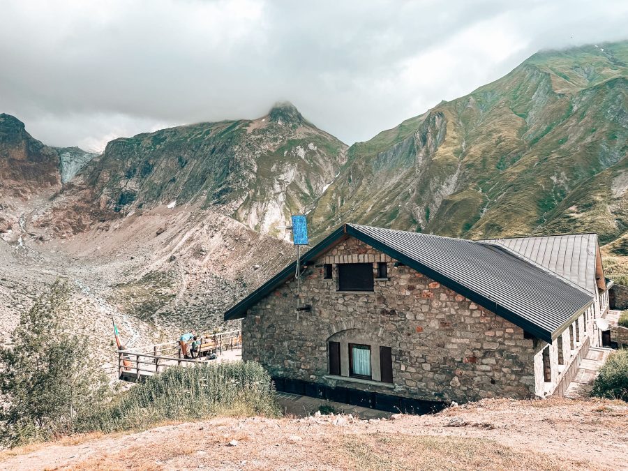 Rifugio Elena underneath the impressive thousand-year-old Prè de Bard glacier on the TMB Hike, Courmayeur, Aosta Valley, Tour du Mont Blanc, Italy