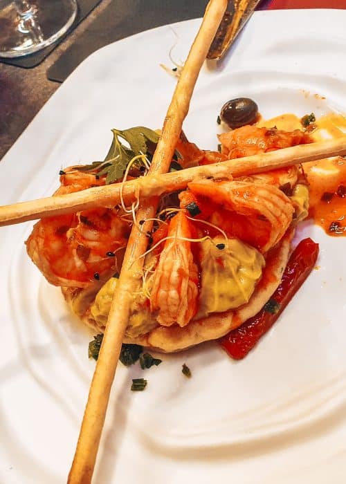 Marinated shrimp and guacamole on a chives blini as a starter in Les Chineurs de la Cuisine in Annecy Old Town, France