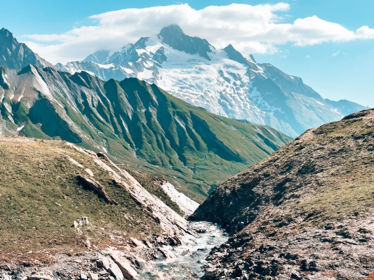 A little stream weaving its way through the snow-capped mountains on the Tour du Mont Blanc, France