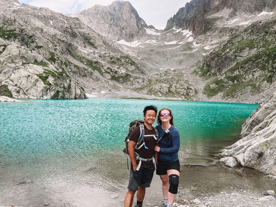 Helen and Andy standing on the shore of Lac Blanc with snow-capped peaks in the background, Chamonix, France