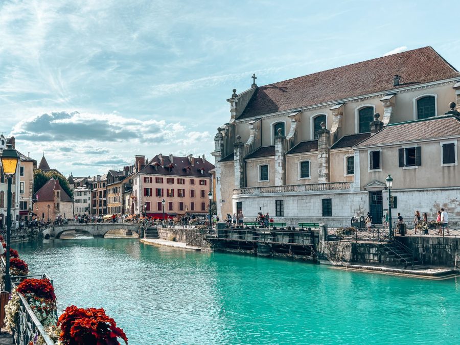 The striking blue Thiou River meandering its way through Annecy Old Town lined with colourful buildings, France