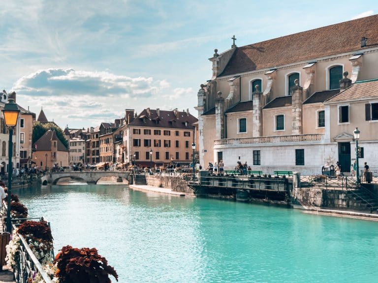 The striking blue Thiou River canals meandering their way through Annecy Old Town lined with colourful buildings, France