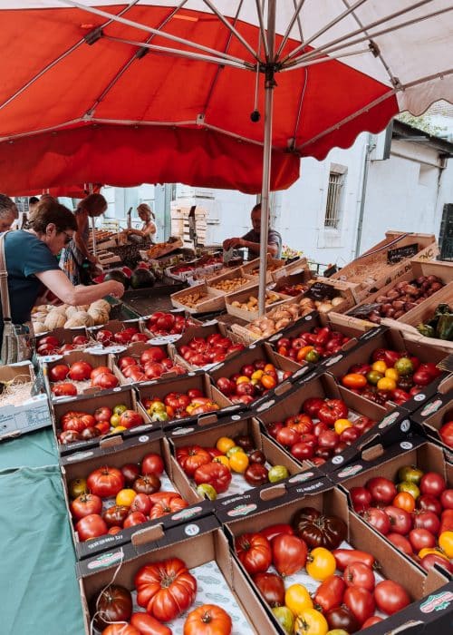 Colourful fruit and veg stalls in the Old Town Market which is one of the best things to do in Annecy, France