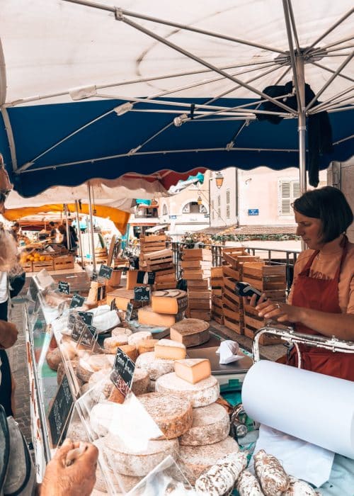 A stall in Annecy Old Town Market with lots of varieties of cheese, France