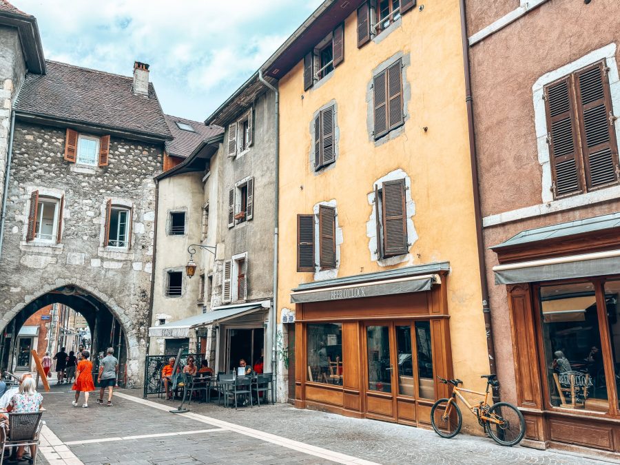 One of the gates of Annecy's old city walls with an arch over the narrow street, things to do in Annecy in summer, France