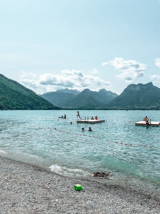 Pontoons in Lake Annecy with people jumping on and playing, Angon Beach, France