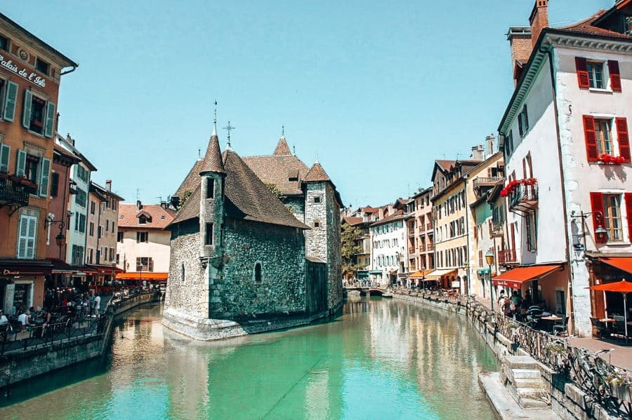 The historic Palais de l'Ile perched on a rocky island on the Thiou in Annecy Old Town, France